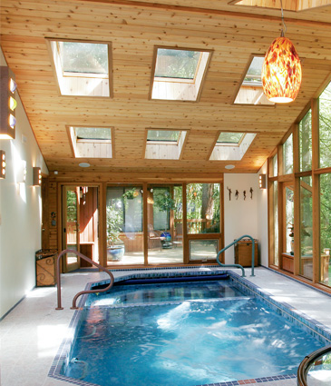 Pool room addition with cedar framing and tiled pool looking across room out the back door