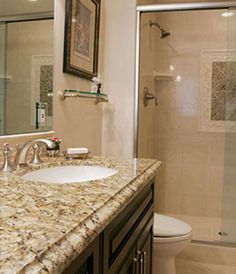 Remodeled bathroom with granite countertops and tiled shower