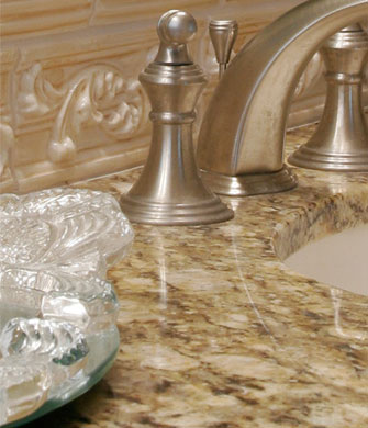 Close up of granite counter tops and brushed nickel fixtures