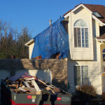 Photo of the exterior of the house with work starting to frame the addition