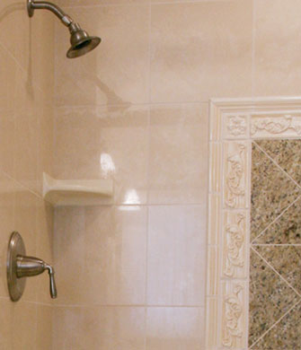 Close up of shower tile work including framed tile inset