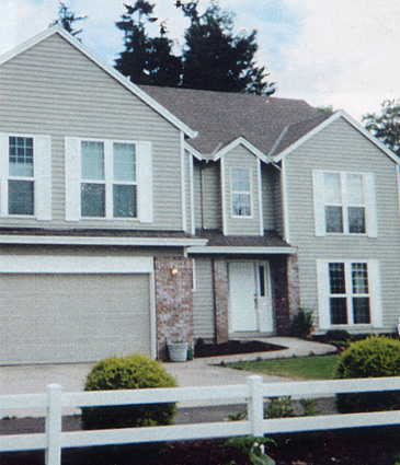 Photo of front of house after second story addition complete showing addition fits seamlessly with the rest of the house.