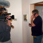 Photo of John Sramek being filmed as he calls a subcontractor