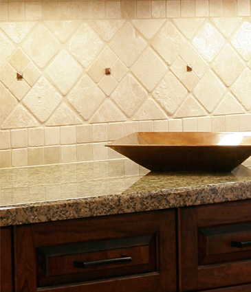 Close up of tile backsplash and granite countertops in remodeled kitchen