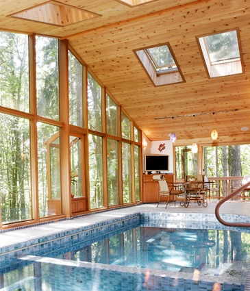 Pool, glass wall on right, and cedar ceiling of pool room addition