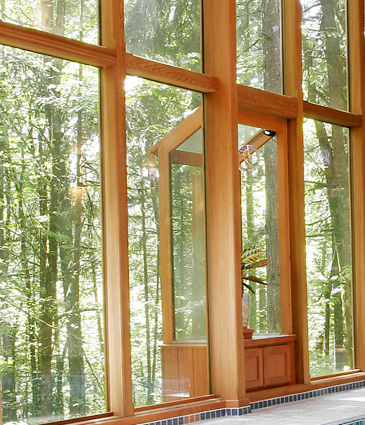 Glass walls of pool room framed in cedar
