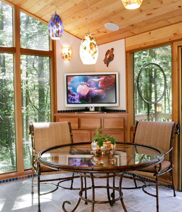 TV nook in pool room addition with flat screen television and glass table