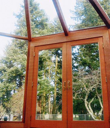 Close up of cedar framing around glass wall sections of sunroom addition