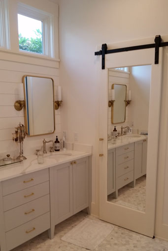 White farm style bathroom vanity with double sinks and mirrors