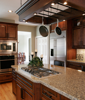 Kitchen with dark wood cabinets and stone countertops