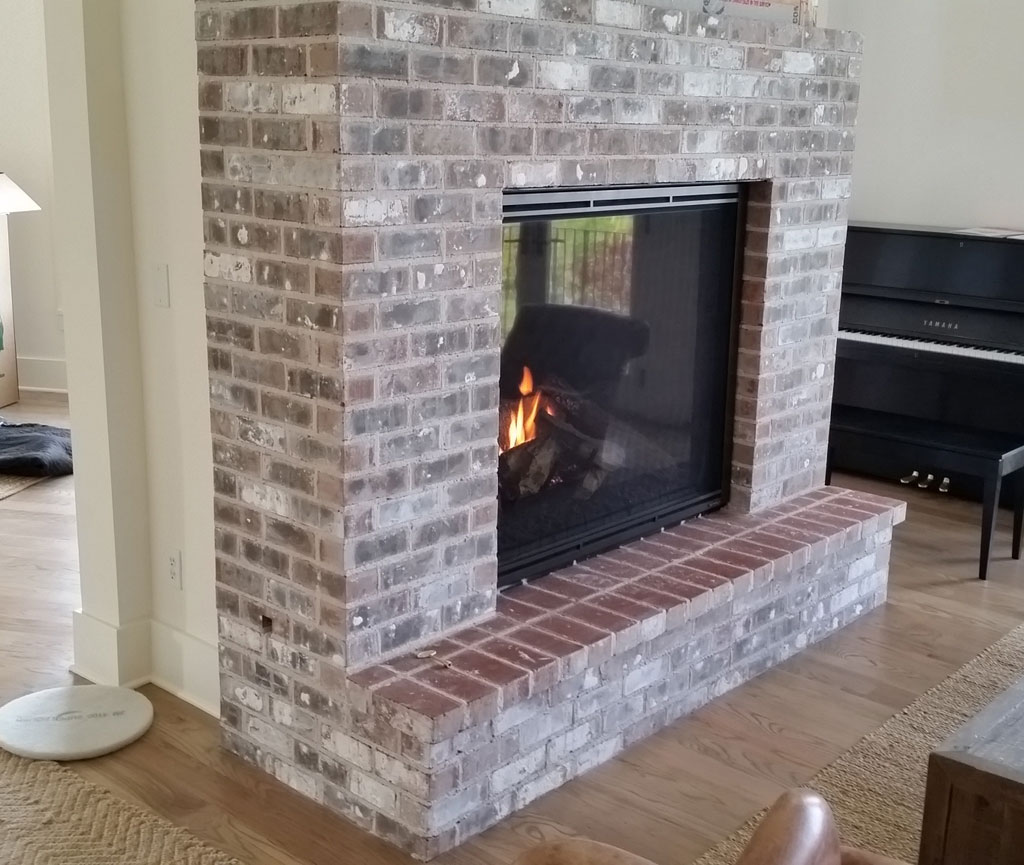 Large brick fireplace open in two directions