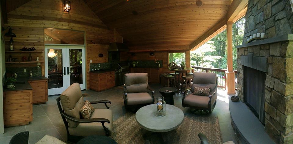 Covered outdoor kitchen and seating area with large fireplace